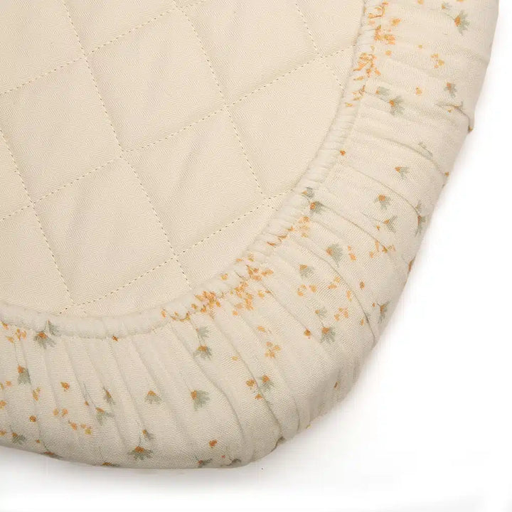 Eco minded nursery scene shows the Charlie Crane Fitted Sheet KUMI and KUKO in milk as eco friendly bedding