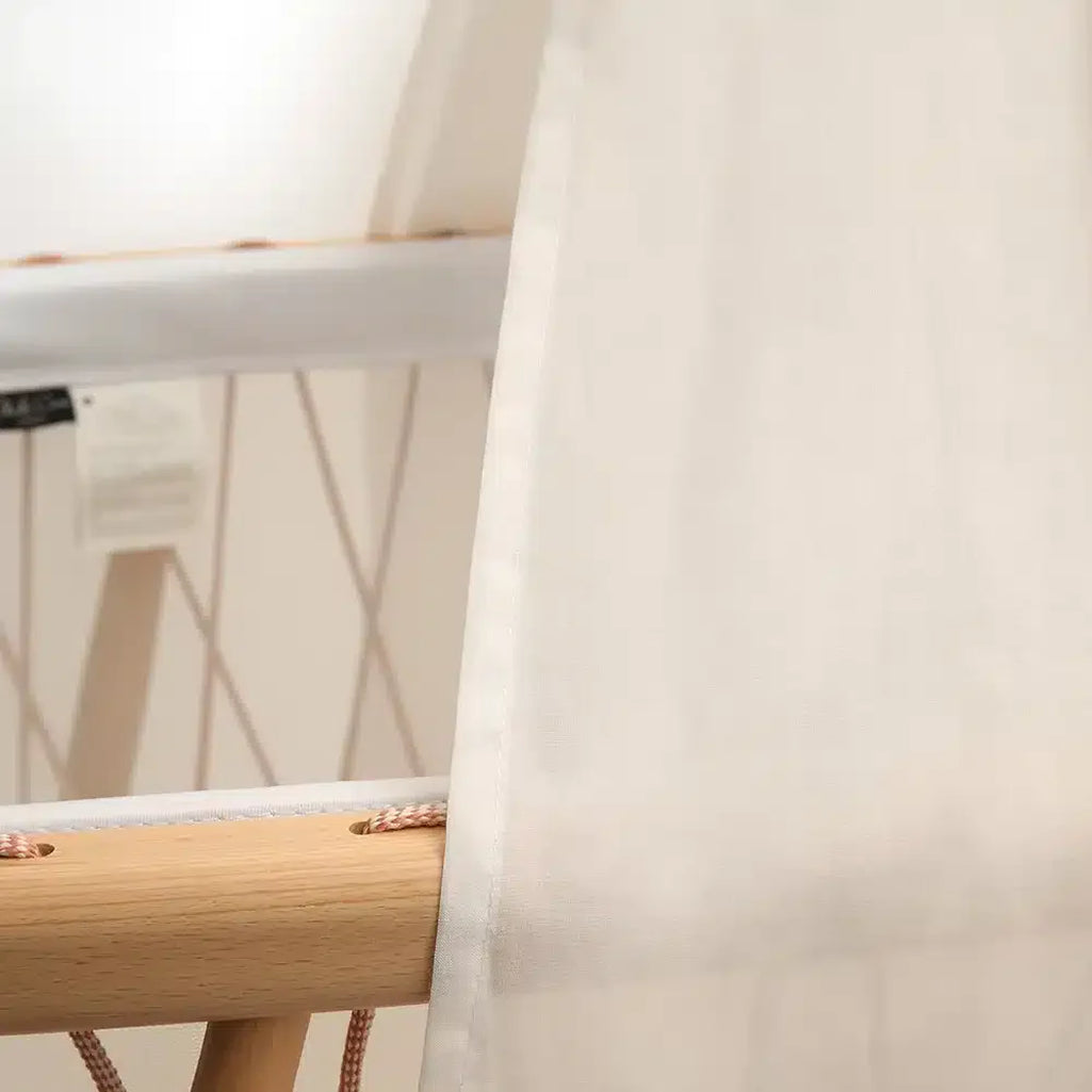 Subtle shading effect displays the KUMI Canopy Charlie Crane in white to help keep crib dark