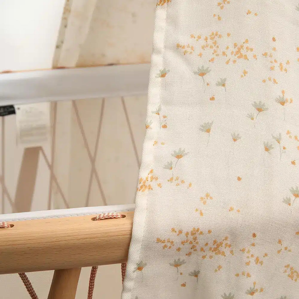 Balanced crib styling features the Charlie Crane Canopy KUMI pia with eco friendly appeal