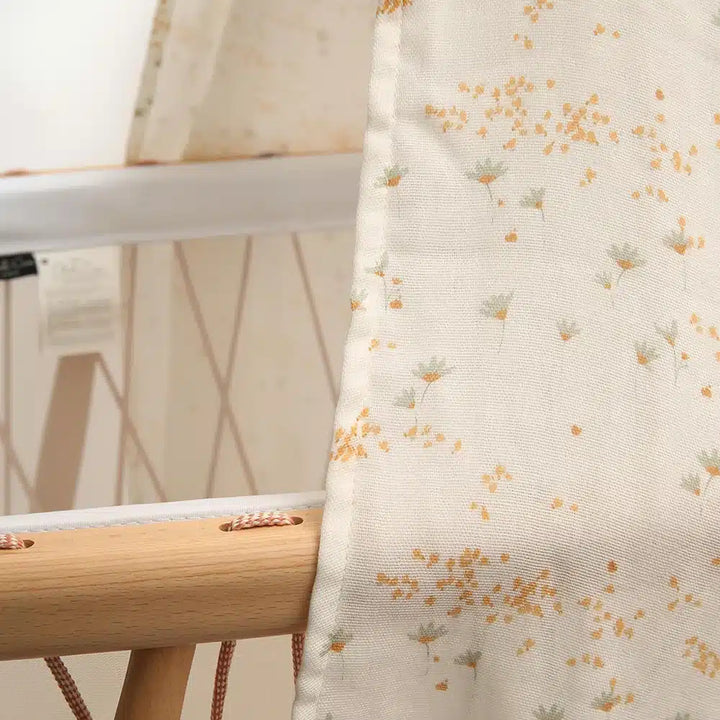 Balanced crib styling features the Charlie Crane Canopy KUMI pia with eco friendly appeal