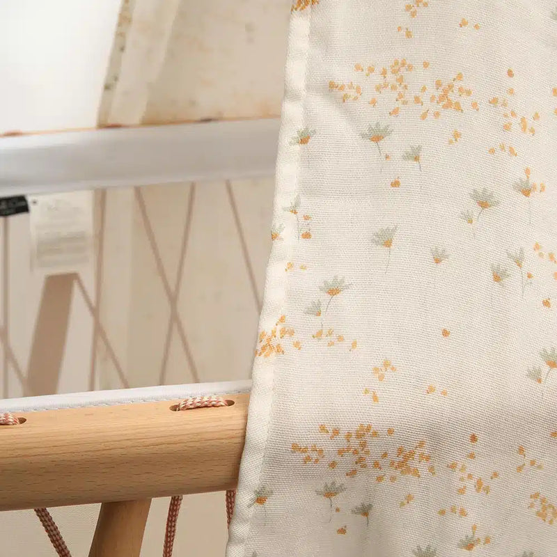 Balanced crib styling features the Charlie Crane Canopy KUMI pia with eco friendly appeal