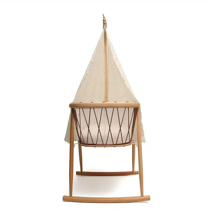 Light filtering detail captures the Canopy KUMI by Charlie Crane in white for newborn safe sleep