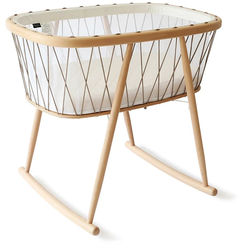 Minimal room scene features the KUMI Charlie Crane Cradle in lichen with minimalist appeal