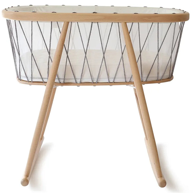 Soft lighting frames the KUMI Cradle by Charlie Crane in desert styled for gentle newborn safe use