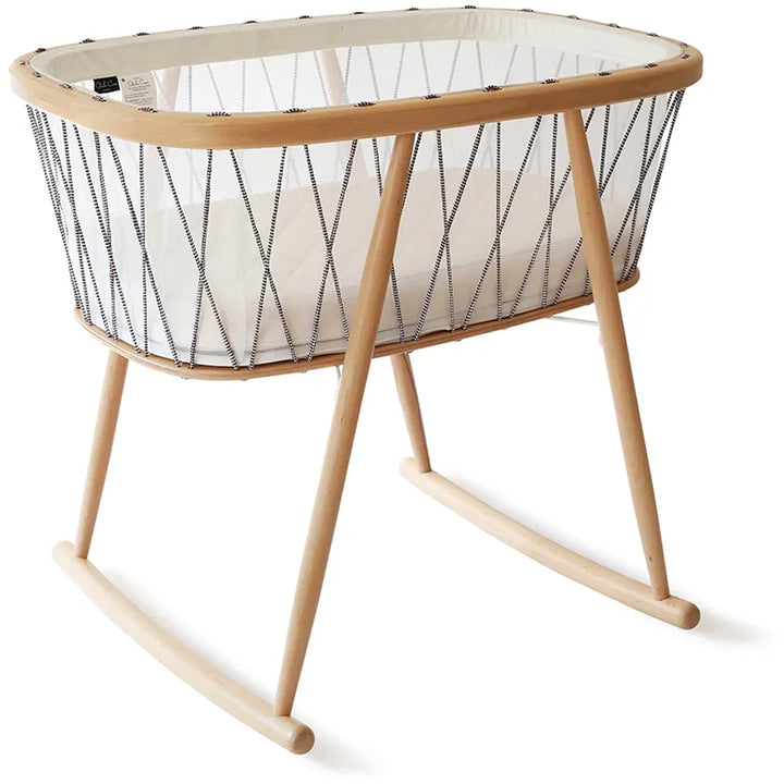 Close view highlights the Charlie Crane KUMI Cradle in bois de rose with rounded wood design