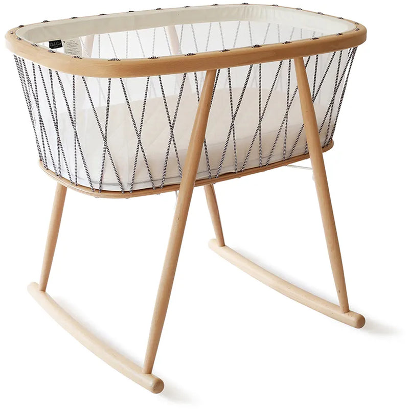Close view highlights the Charlie Crane KUMI Cradle in bois de rose with rounded wood design