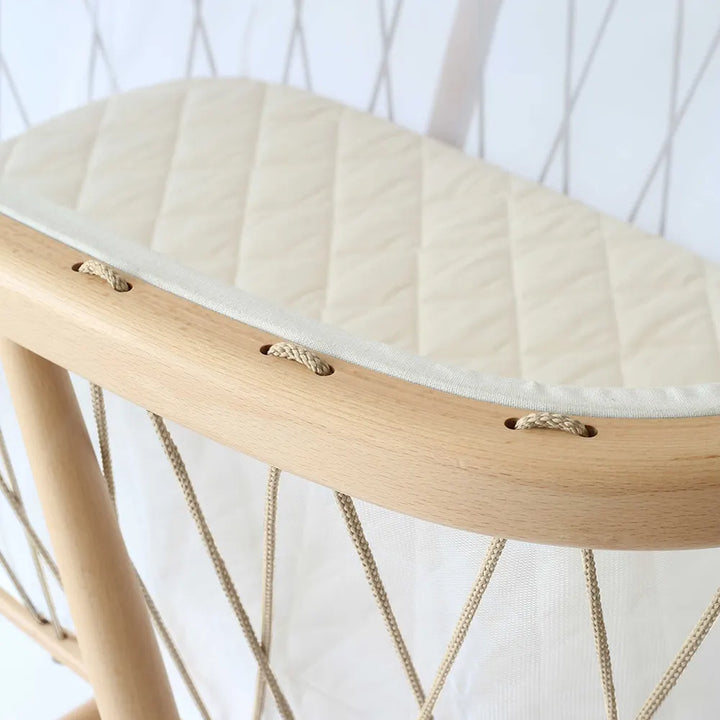 Soothing cradle scene highlights the KUMI Charlie Crane Cradle in lichen designed for infant use