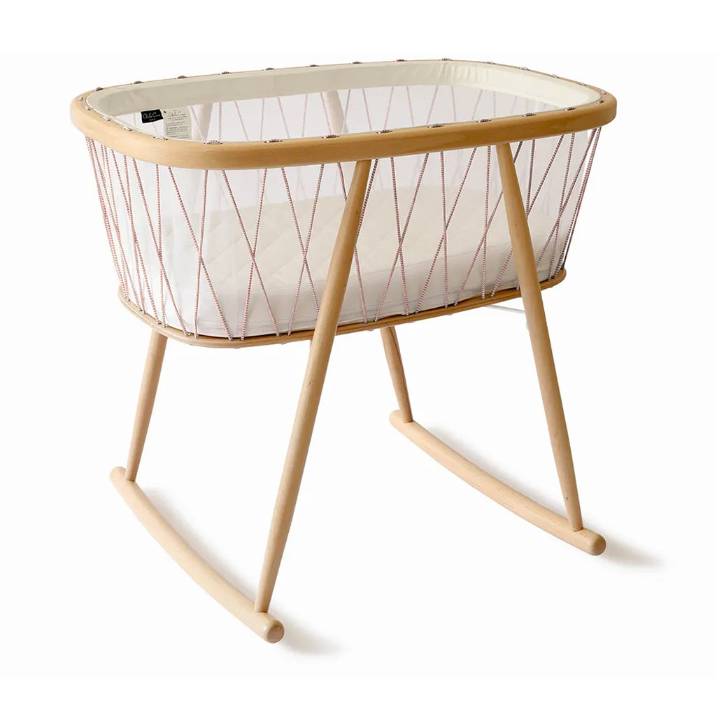 Calm infant setting presents the KUMI Charlie Crane Cradle in lichen with minimalist appeal