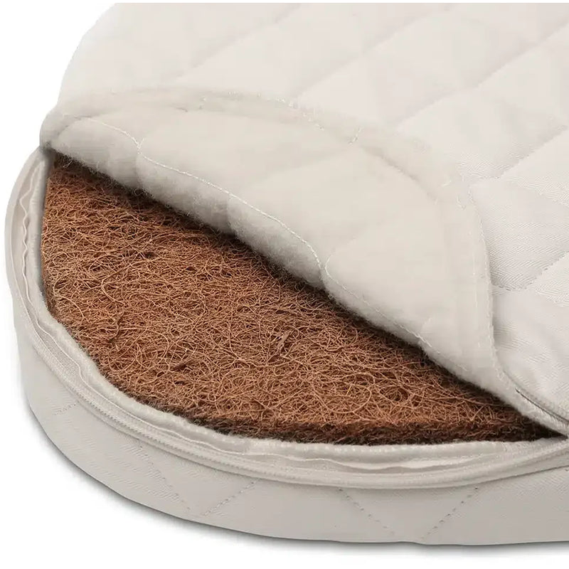 Rounded wood detail highlights the Charlie Crane Cradle KUMI in hazelnut crafted for baby comfort