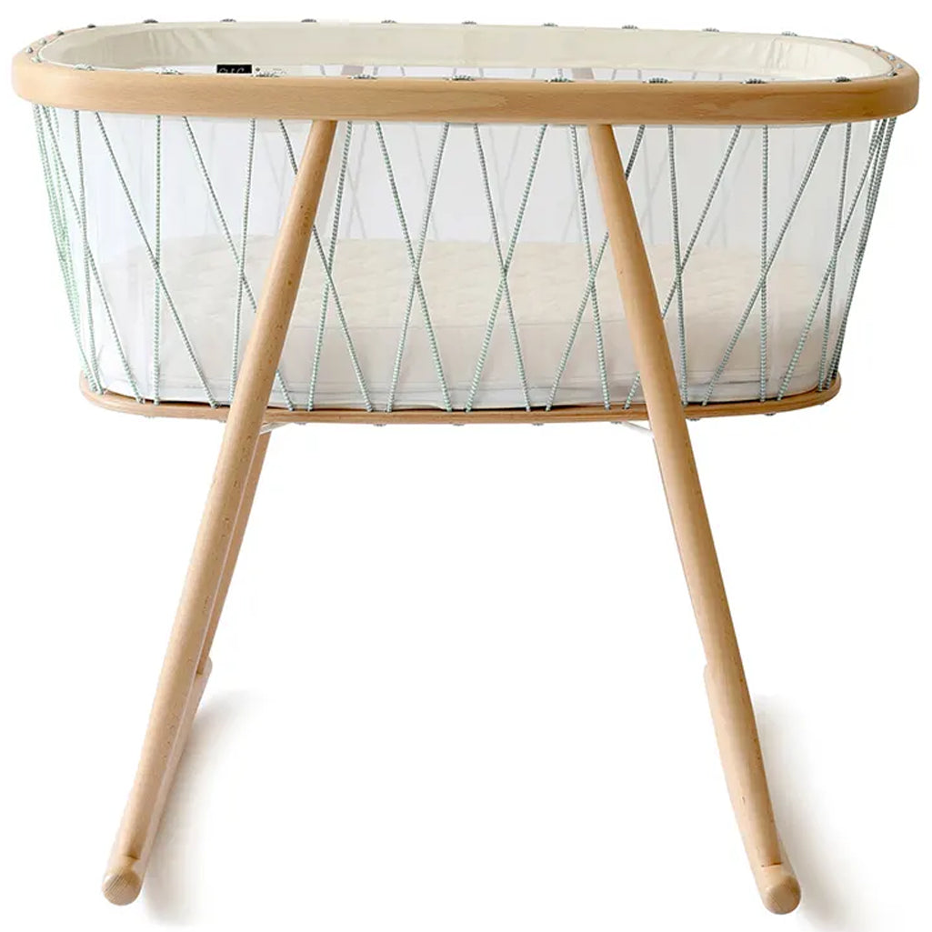 Overhead nursery view shows the Charlie Crane KUMI Cradle in bois de rose with minimalist styling