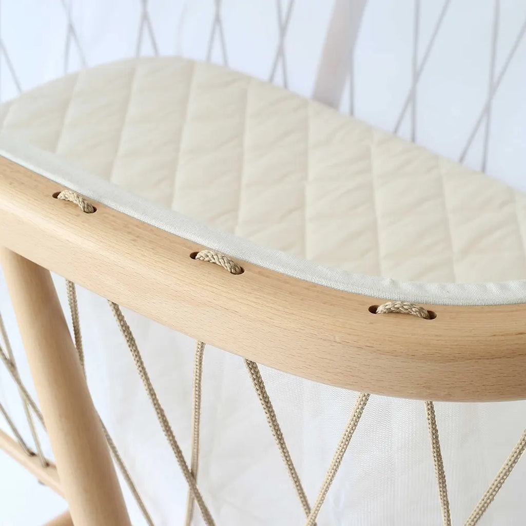 Refined wooden frame displays the Charlie Crane KUMI Cradle hazelnut with sophisticated finish