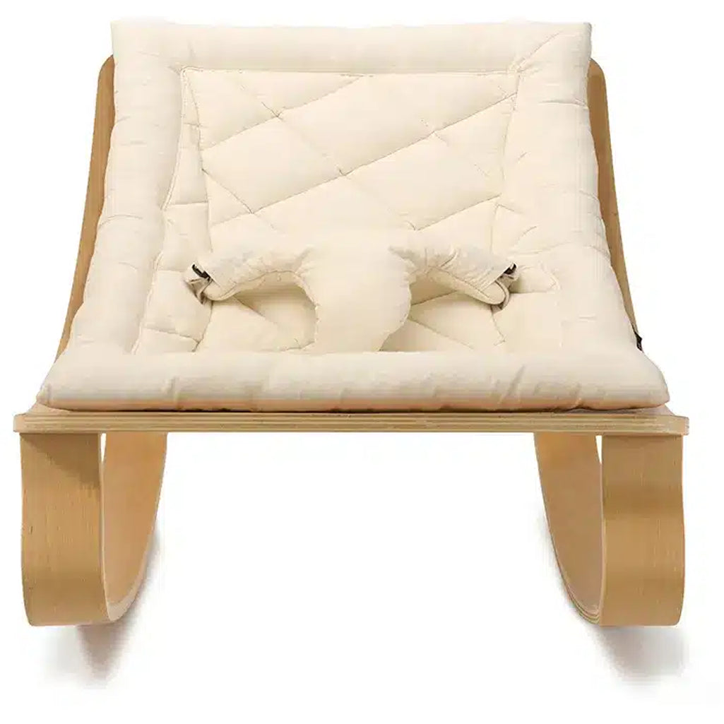 Clean lines define the Charlie Crane Beech Wood Levo Rocker in milk fur, a minimalist bouncer and rocker for baby