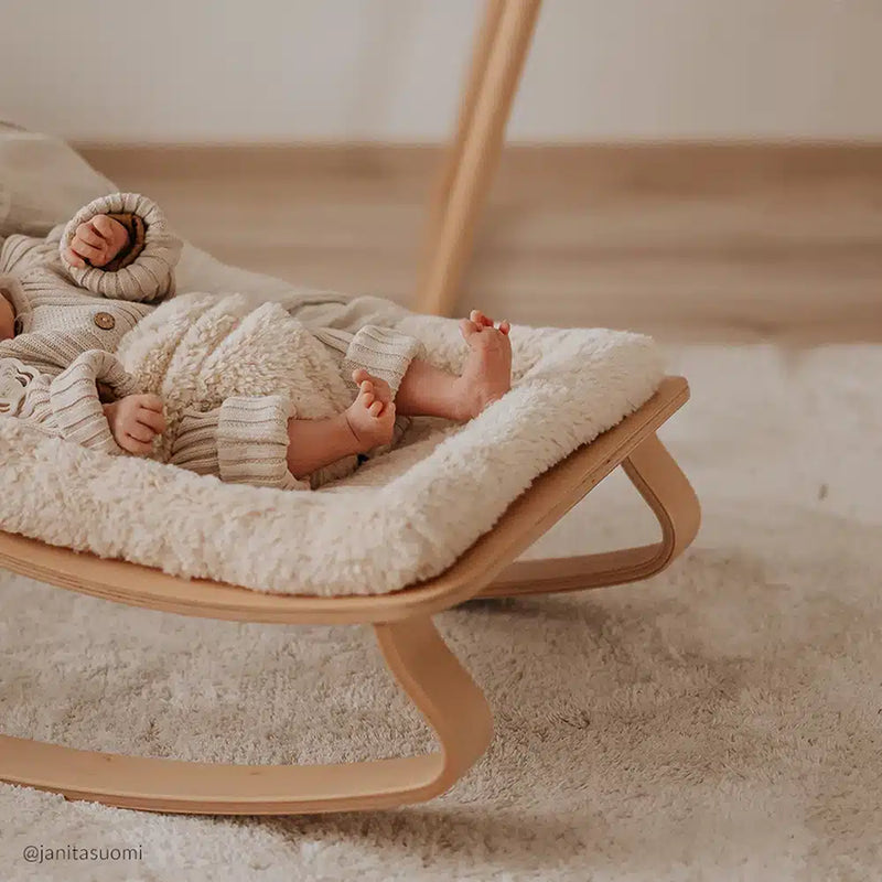Elegant curves frame the Charlie Crane Levo Rocker in milk fur, a baby safe rocker with organic style