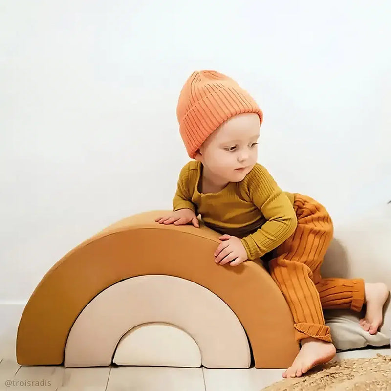 Playful floor setup highlights the MILO Rainbow by Charlie Crane in rosewood suited for infant use