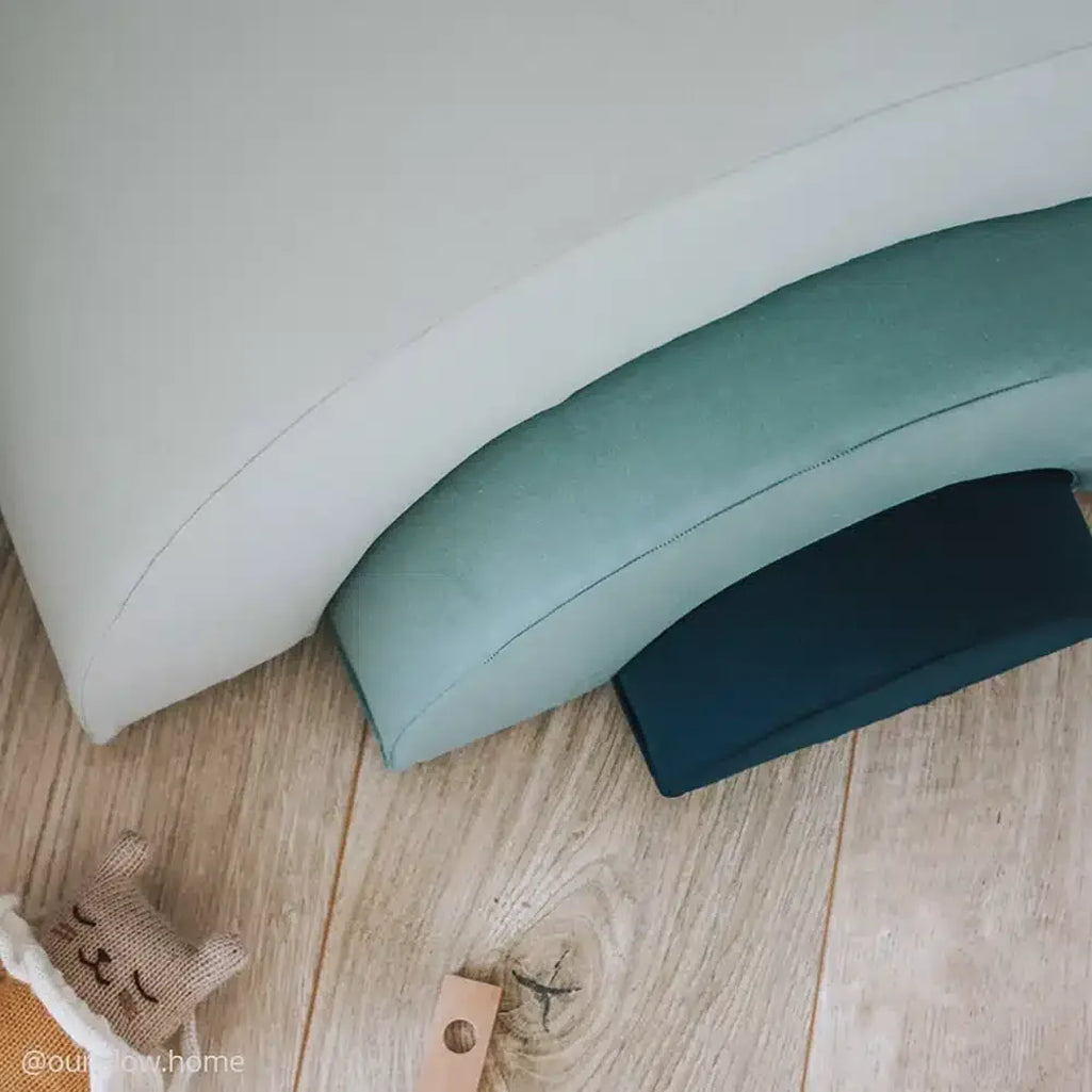 Minimal play space frames the Charlie Crane MILO Rainbow Toy in camel with a sophisticated look