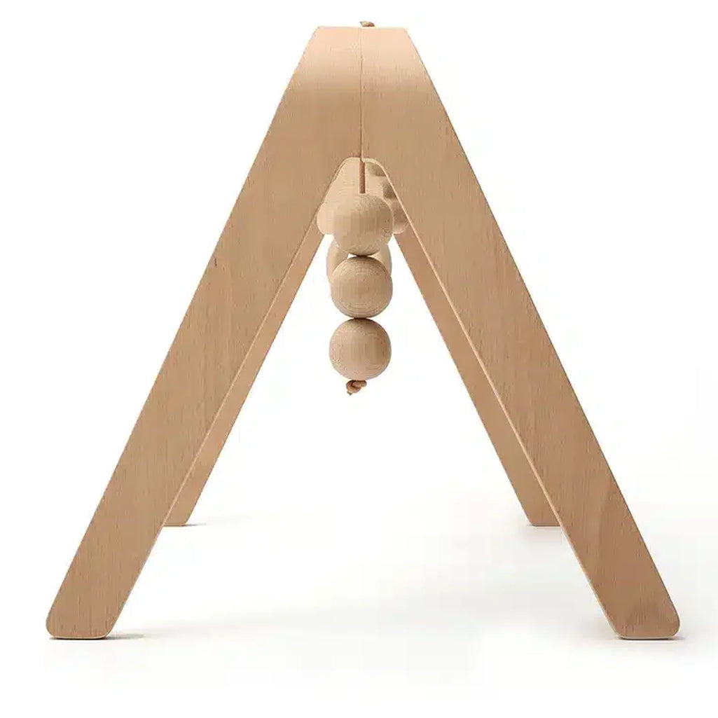 Clean interior styling highlights the Charlie Crane NAHO Arch & Toys in natural with a minimalist play arch aesthetic