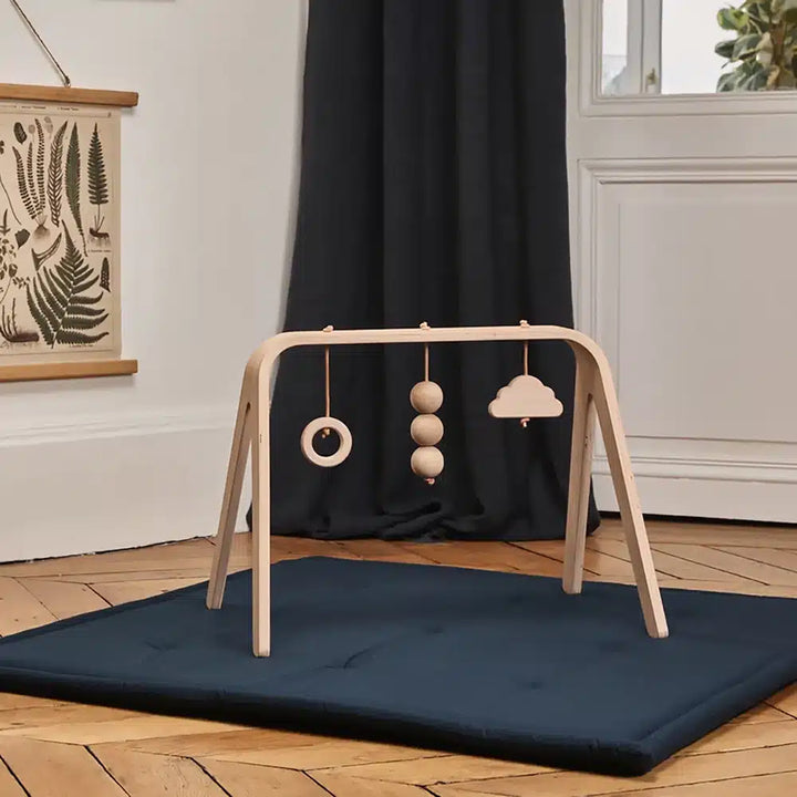 Close detail view presents the Charlie Crane NAHO Arch & Toys in natural reflecting refined French nursery decor