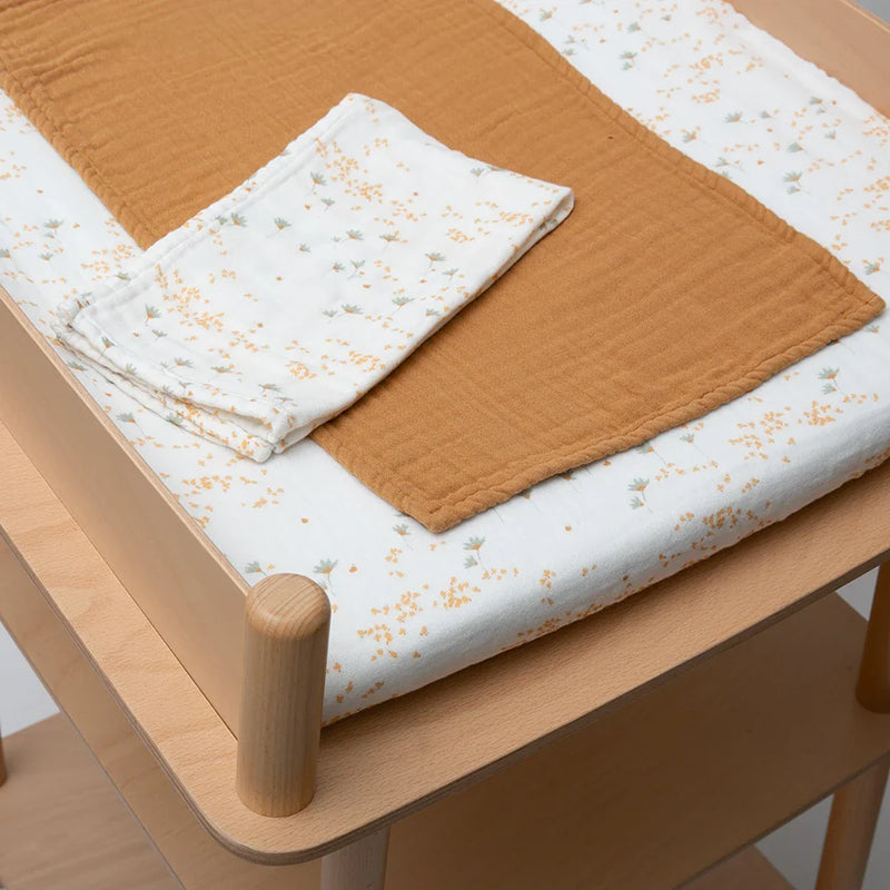 yellow pia flowers with camel brown swaddle on charlie crane nago diaper changing mat