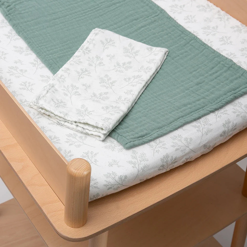 pearl gray floral organic cotton pago diaper changing station with charlie crane lichen swaddle 