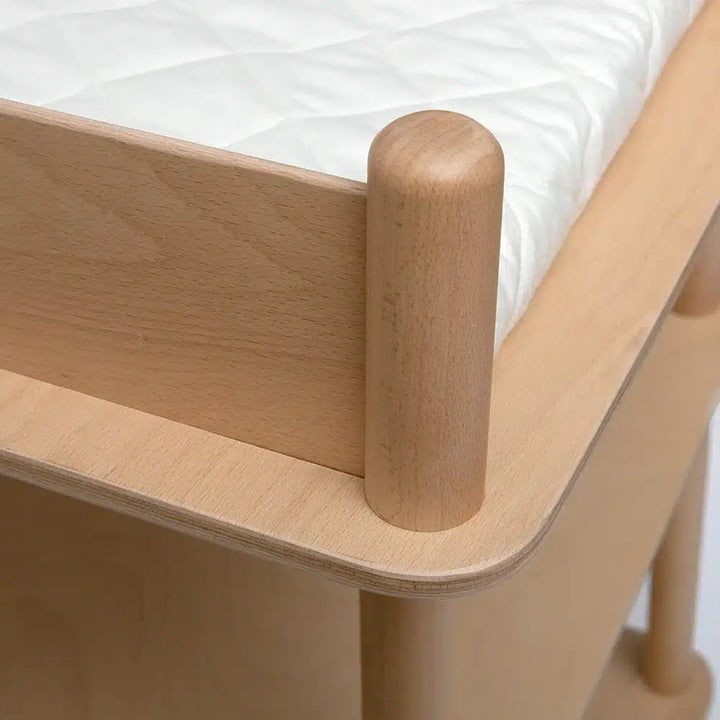 close up of handmade wooden pago charlie crane changing table showcasing soft sanded edges