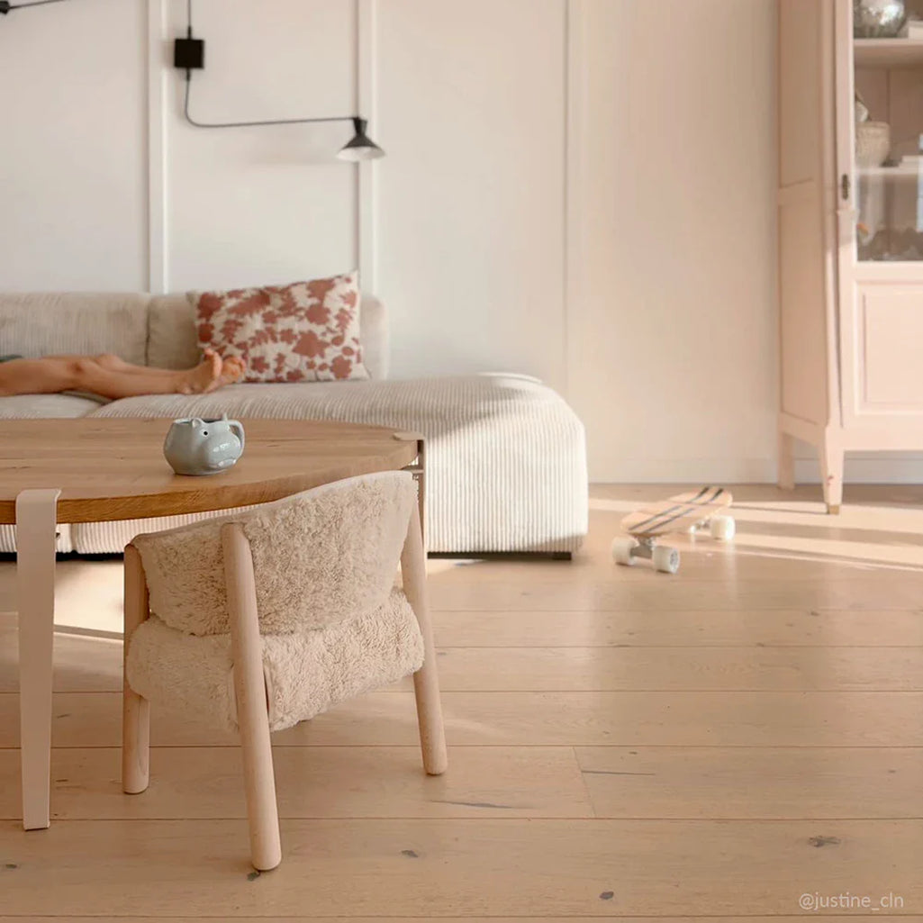 Minimal room setup frames the Charlie Crane SABO Fur Chair in milk designed as a minimalist baby chair