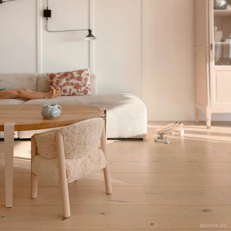 Minimal room setup frames the Charlie Crane SABO Fur Chair in milk designed as a minimalist baby chair