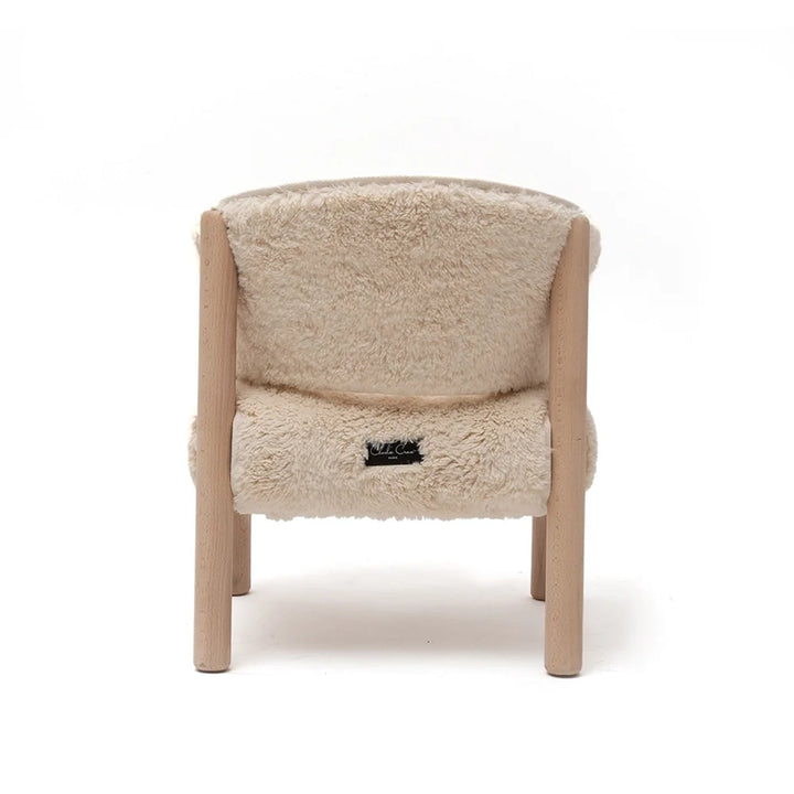 Cozy reading corner shows the Charlie Crane SABO Fur Chair in milk with a sophisticated nursery decor look