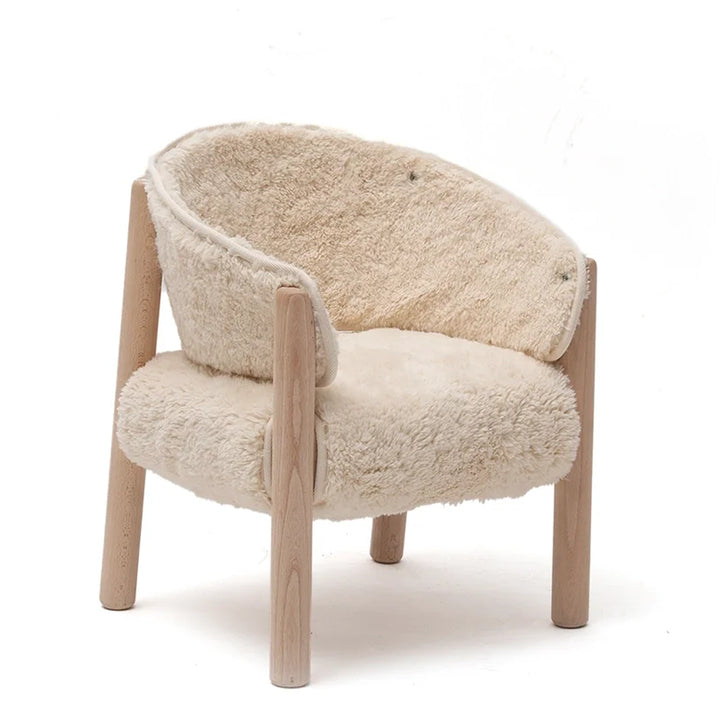 Angled nursery view features the Charlie Crane SABO Fur Chair in milk with a midcentury modern silhouette