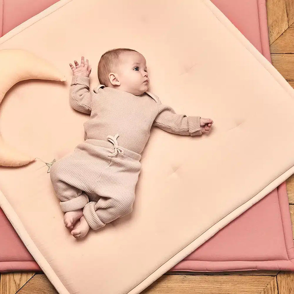 baby lying on nude charlie crane playmat tami 