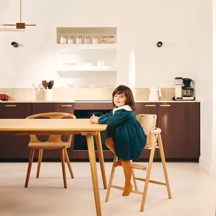 child in modern sleek kitchen sitting on the tobo adjustable high chair 