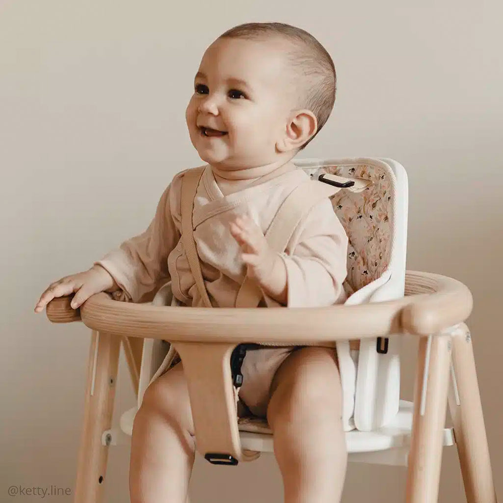 infant laughing in charlie crane tobo natural high chairand sitting in tobo adjustable baby seat 
