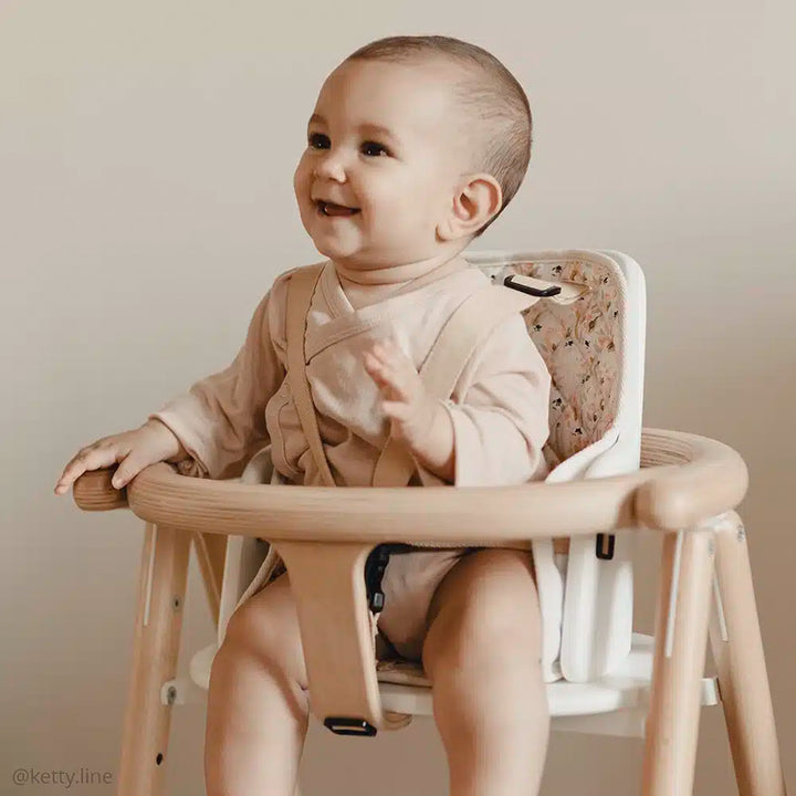 infant laughing in charlie crane tobo natural high chairand sitting in tobo adjustable baby seat 