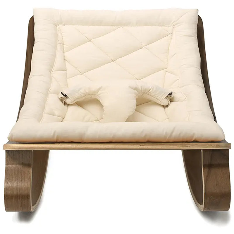 Refined styling shows the Charlie Crane Walnut Wood Levo Rocker in milk fur with a sophisticated look