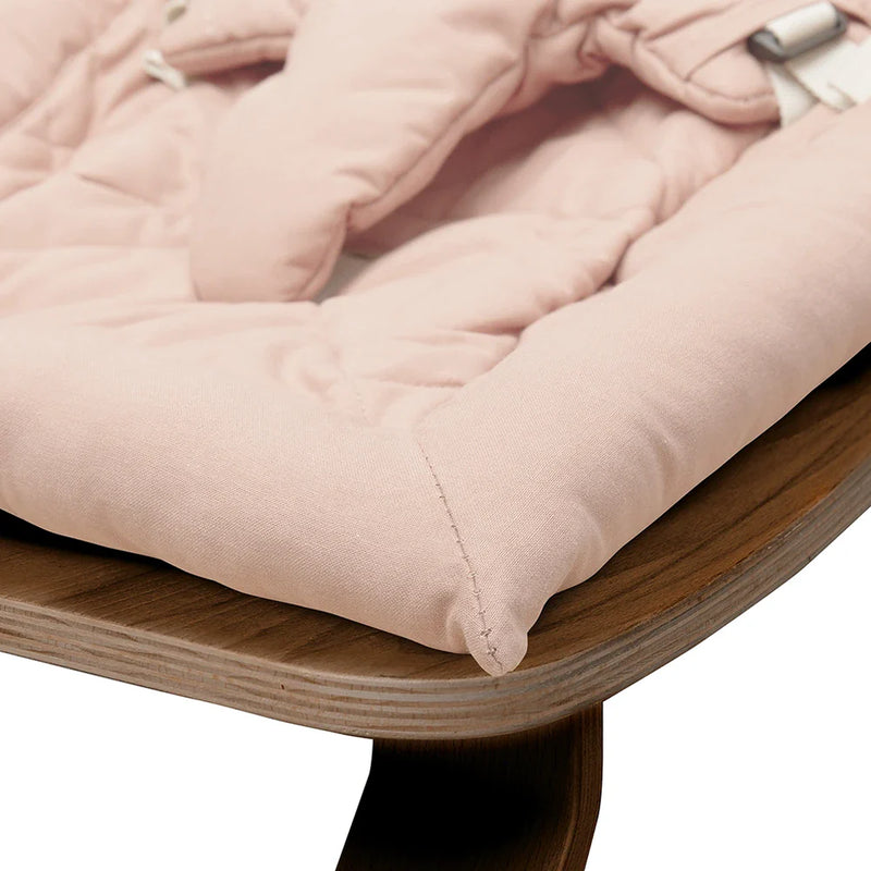 Side angle view of the Levo Rocker Walnut Wood from Charlie Crane in camel as a bouncer and rocker design