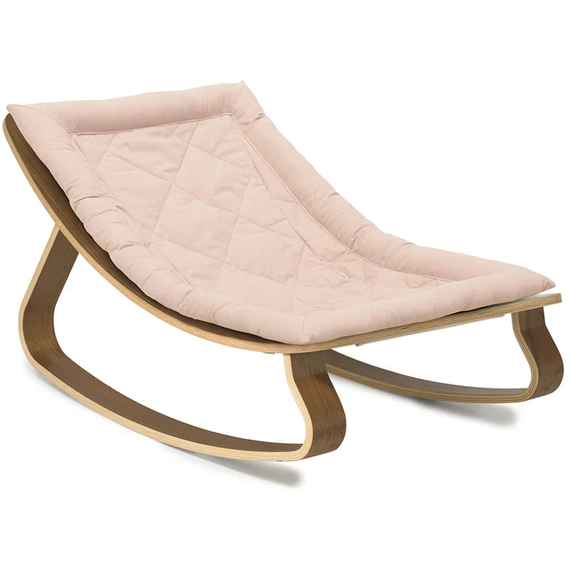 Minimal interior styling frames the Charlie Crane Walnut Wood Levo Rocker in organic milk as a minimalist baby rocker