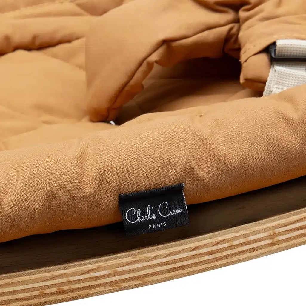 Modern nursery decor scene featuring the Levo Rocker Walnut Wood from Charlie Crane in mimosa for baby spaces