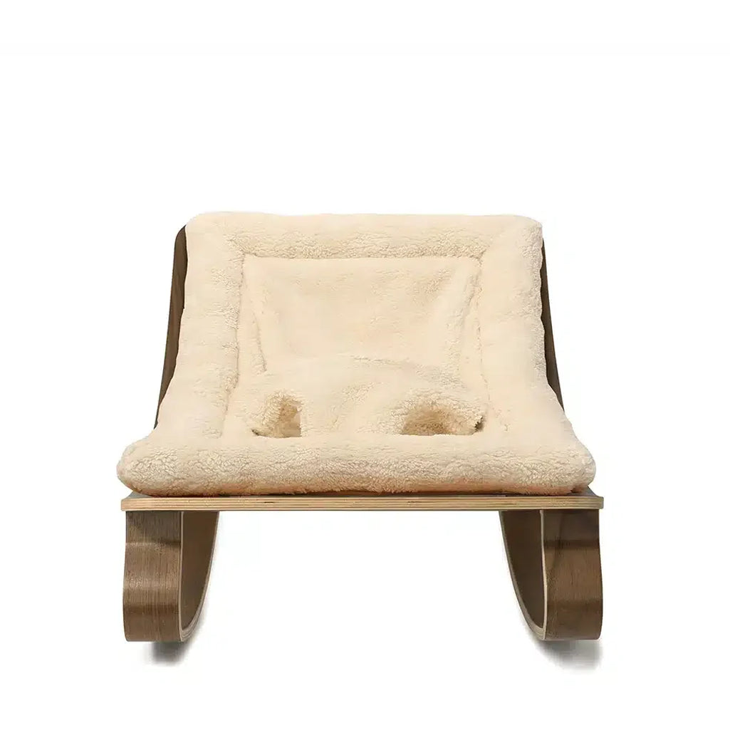 Side angle of the Levo Rocker Walnut Wood from Charlie Crane in camel, offering a bouncer and rocker design