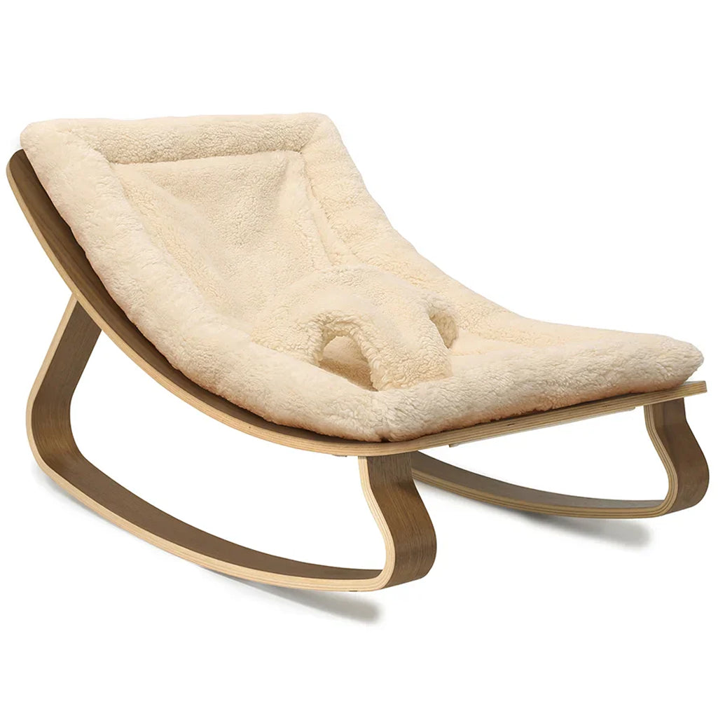 Soft upholstery detail on the Walnut Wood Levo Rocker by Charlie Crane in mimosa, designed as a baby bouncer