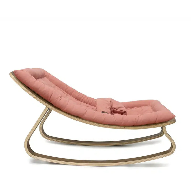 Subtle curves and tone define the Charlie Crane Levo Rocker in walnut wood and organic milk, crafted for infant relaxation