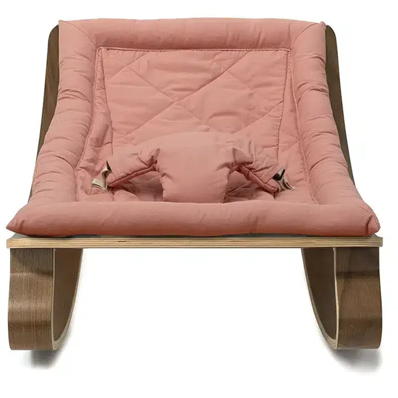 Contemporary nursery styling highlights the Levo Rocker Walnut Wood from Charlie Crane in mimosa, perfect for baby spaces