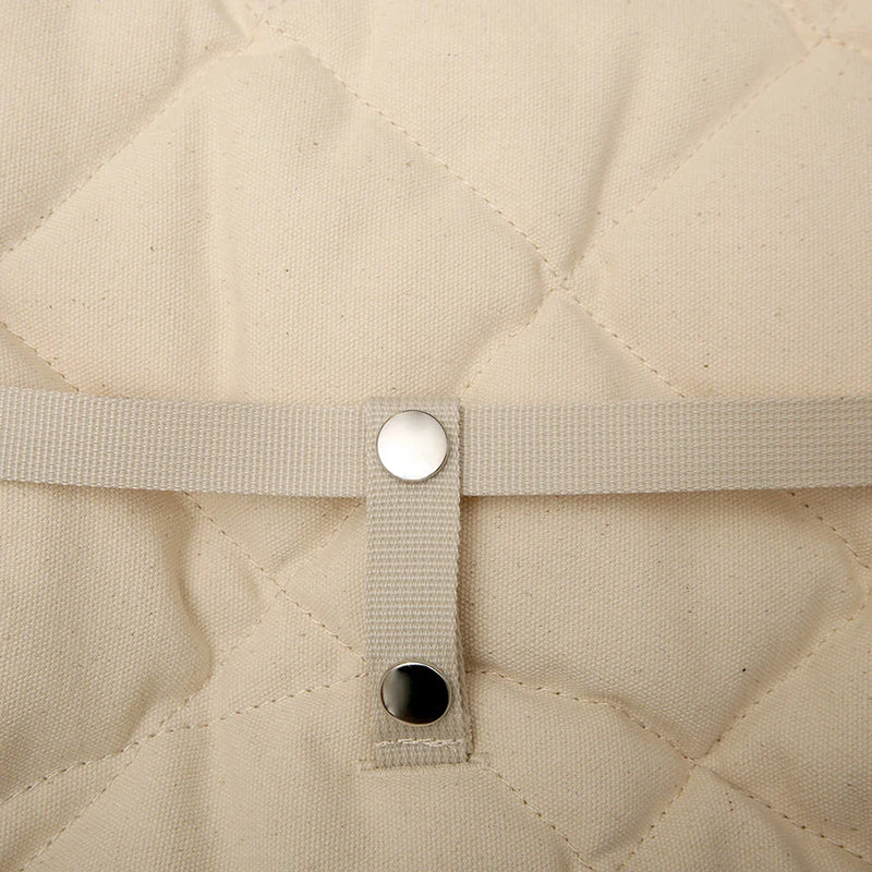 Textural focus on the walnut frame of the Levo Rocker by Charlie Crane in camel, a wooden infant rocker