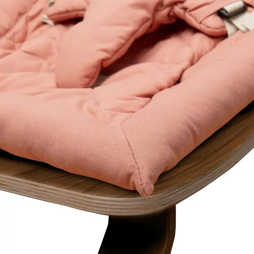 Modern home setting with the Charlie Crane Walnut Wood Levo Rocker in milk fur, designed as a baby bouncer