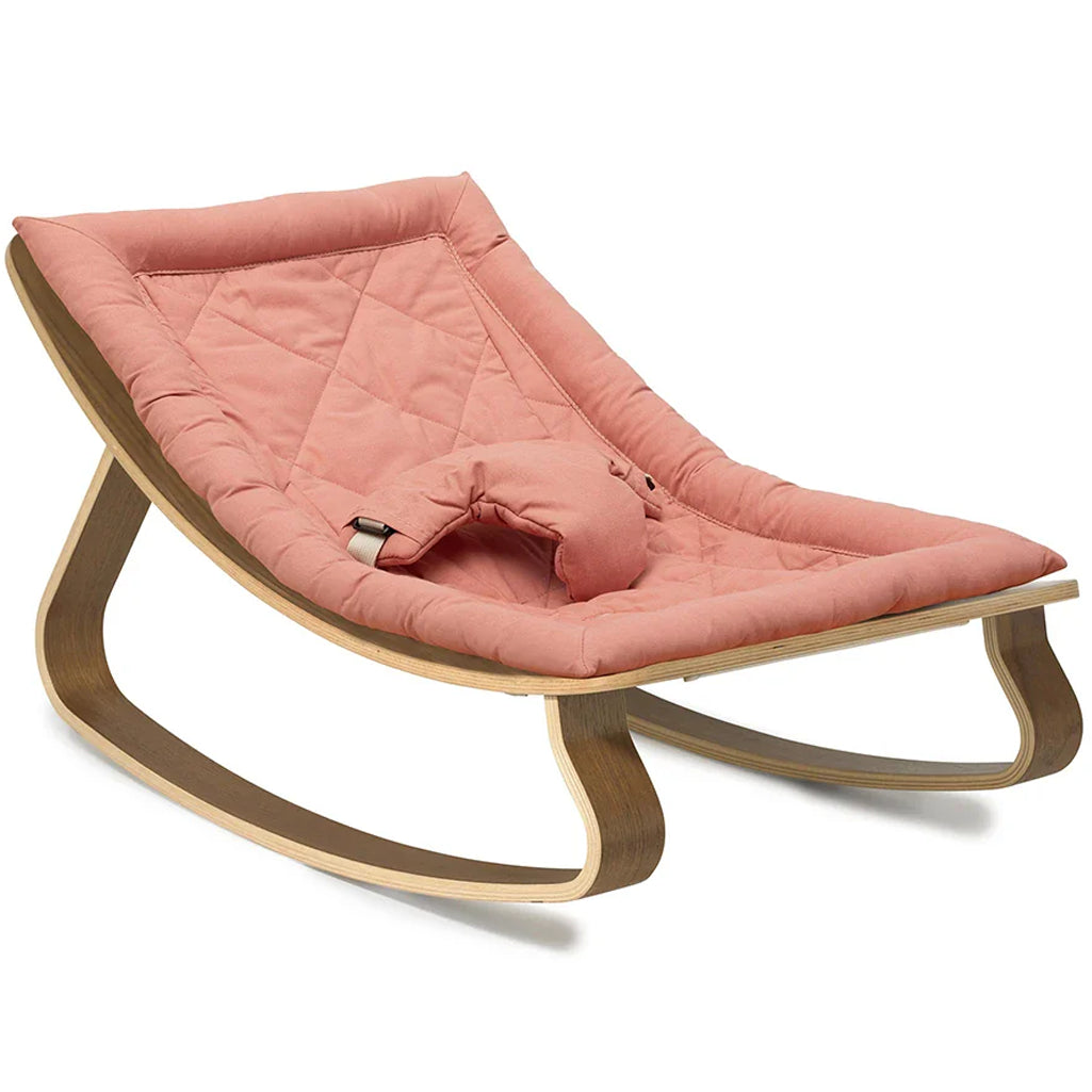 Balanced proportions of the Charlie Crane Levo Rocker in walnut wood and organic milk support newborn safe lounging