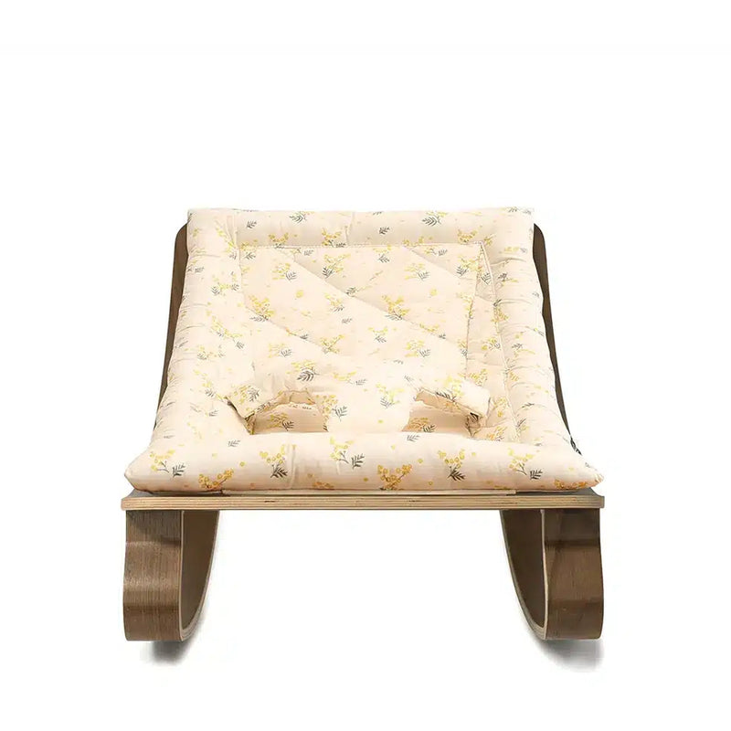 Minimal interior styling frames the Levo Rocker Walnut Wood from Charlie Crane in mimosa, a minimalist baby bouncer