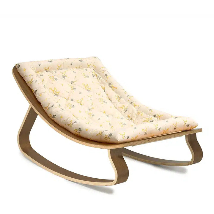 Front facing view of the Levo Rocker in walnut wood by Charlie Crane in organic milk, highlighting its adjustable seat