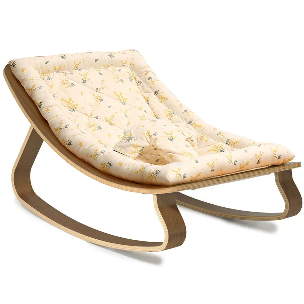 A refined nursery scene with Charlie Crane Levo Rocker Walnut Wood in mimosa, styled as midcentury modern nursery decor