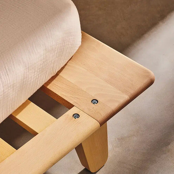 close up of charlie crane yomi junior bed frame showcasing its raw wood finish and sophisticated design