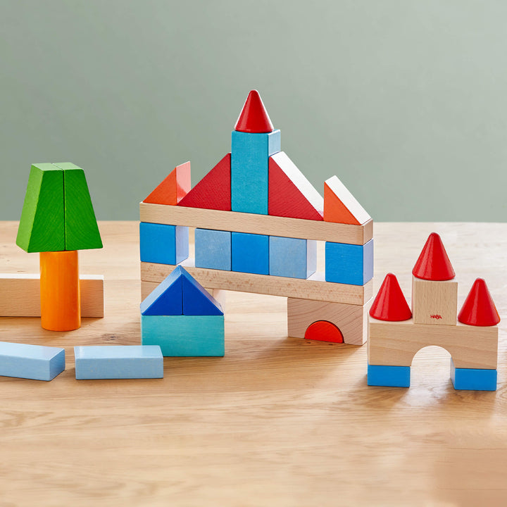 Toddlers explore colors and shapes with HABA Colored Wooden Building Blocks, a best toddler toy.
