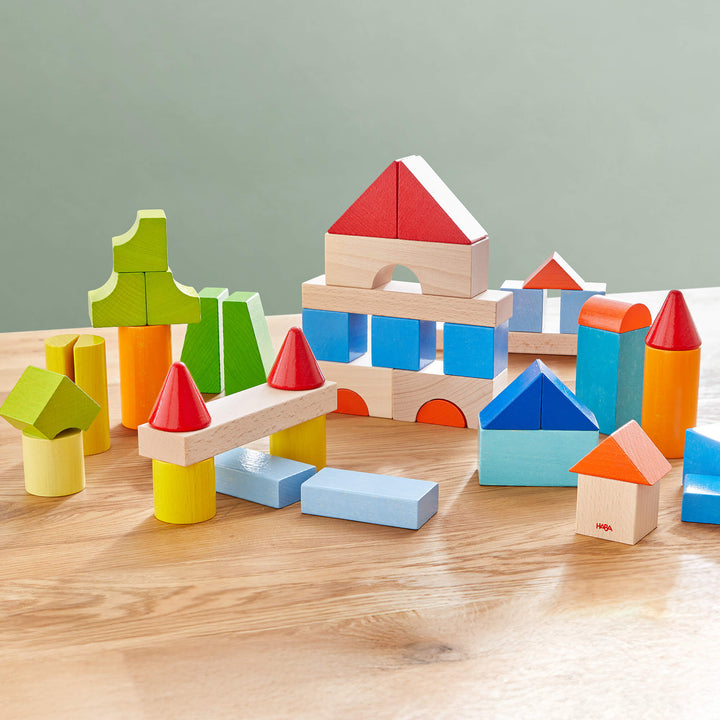 Create towers and designs using HABA Colored Wooden Building Blocks, an educational toy for young minds.