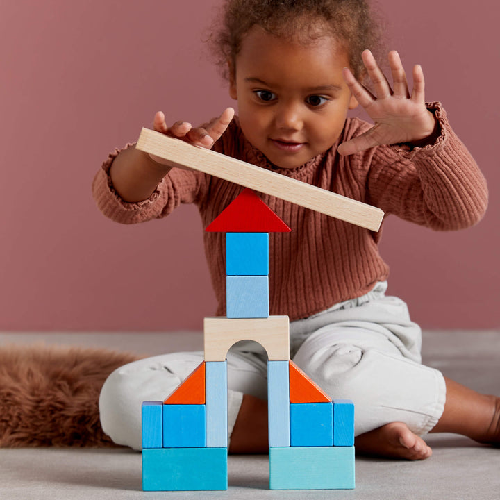 Little builders enjoy HABA Colored Wooden Building Blocks, a kids toy perfect for learning through play.